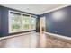 Bright home office features dark blue walls, hardwood floors, and three large windows at 9972 Ashton Old Rd, Douglasville, GA 30135