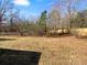 Spacious backyard with mature trees and wooden privacy fence at 220 Mountain Way, Covington, GA 30016