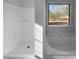 Bathroom with shower and garden tub, large window at 220 Mountain Way, Covington, GA 30016