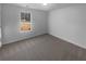 Well-lit bedroom featuring carpet floors and a large window at 220 Mountain Way, Covington, GA 30016