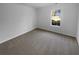 Simple bedroom with gray carpeting and a large window at 220 Mountain Way, Covington, GA 30016