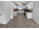 Bright kitchen with white cabinets, dark countertops, and vinyl flooring at 220 Mountain Way, Covington, GA 30016