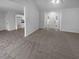 Bright and spacious living room with carpet flooring and view into kitchen area at 220 Mountain Way, Covington, GA 30016