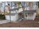 Beige two-story house with double garage and landscaping at 3901 W Wood Path, Stone Mountain, GA 30083