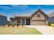 Inviting ranch home with stone accents and a landscaped lawn at 780 Codex Dr, Fairburn, GA 30213