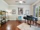 Music room with grand piano, hardwood floors, and built-in shelving at 1891 Prospect Church Rd, Lawrenceville, GA 30043