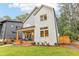 Two-story modern farmhouse with gray and white siding, a covered porch, and landscaped yard at 1356 Deerwood Dr, Decatur, GA 30030