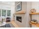 Modern fireplace with light gray tile surround and wood mantel at 1356 Deerwood Dr, Decatur, GA 30030