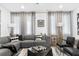 Modern living room featuring a gray sectional sofa and large windows at 388 Pratt Se Dr # 2122, Atlanta, GA 30315