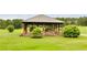 Wooden gazebo with stone pillars and landscaping at 1094 Plantation Ct, Villa Rica, GA 30180