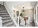 Dining room with gray carpeting, wooden table, and geometric accent wall at 118 Bellington Dr, Mcdonough, GA 30253