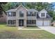 Two-story brick home with a three-car garage and landscaped lawn at 118 Bellington Dr, Mcdonough, GA 30253