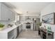 Modern kitchen with gray cabinets, white subway tile, and stainless steel appliances at 118 Bellington Dr, Mcdonough, GA 30253