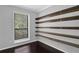 Cozy bedroom features modern shelving and natural light at 2510 Cumberland Se Ct, Smyrna, GA 30080