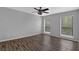 Bright, empty bedroom features two large windows with blinds, wood floors, and a ceiling fan at 2510 Cumberland Se Ct, Smyrna, GA 30080