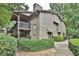 View of exterior of home with balcony overlooking green shrubs and mature trees at 2510 Cumberland Se Ct, Smyrna, GA 30080