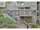 View of exterior with fenced patio on a hillside with luscious landscaping and shrubbery at 2510 Cumberland Se Ct, Smyrna, GA 30080