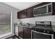 Well-lit kitchen with modern appliances, granite countertops, and dark cabinetry at 2510 Cumberland Se Ct, Smyrna, GA 30080