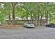 View of parking lot surrounded by trees and landscaping, with residences in the background at 2510 Cumberland Se Ct, Smyrna, GA 30080