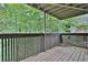 View of the wooden fenced patio overlooking a green space with mature trees at 2510 Cumberland Se Ct, Smyrna, GA 30080