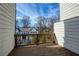 A quaint wooden balcony with scenic neighborhood views under a bright blue sky at 4382 Benfield Se Way, Smyrna, GA 30080