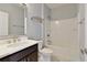 Well-lit bathroom features shower-tub combo with silver fixtures and dark wood vanity at 4382 Benfield Se Way, Smyrna, GA 30080