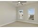 A neutral tone bedroom featuring two windows providing city views and natural light at 4382 Benfield Se Way, Smyrna, GA 30080