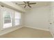 Cozy bedroom features neutral carpet, natural light from large windows, and a ceiling fan, creating a comfortable retreat at 4382 Benfield Se Way, Smyrna, GA 30080