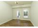 Bright and airy dining room features hardwood floors, a contemporary light fixture, and natural light from the windows at 4382 Benfield Se Way, Smyrna, GA 30080