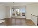 An elegant dining room with modern lighting fixtures and large windows that provide an outside view at 4382 Benfield Se Way, Smyrna, GA 30080