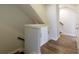 Hallway with cabinets and hardwood flooring leading to the stairs at 4382 Benfield Se Way, Smyrna, GA 30080