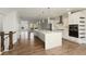 Stylish kitchen featuring hardwood floors, stainless steel appliances, island, pendant lights, and white cabinets at 4382 Benfield Se Way, Smyrna, GA 30080