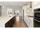 Modern kitchen with stainless steel appliances, white cabinets, and hardwood floors at 4382 Benfield Se Way, Smyrna, GA 30080