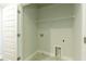 A laundry room with tile floors, washer/dryer hookups and shelving at 4382 Benfield Se Way, Smyrna, GA 30080