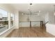 Bright living room featuring hardwood floors, large windows, modern lighting, and an open staircase at 4382 Benfield Se Way, Smyrna, GA 30080