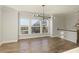 Bright living room featuring hardwood floors, large windows, and modern lighting fixture at 4382 Benfield Se Way, Smyrna, GA 30080