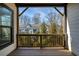 A covered porch provides an outdoor view of trees and townhomes at 4382 Benfield Se Way, Smyrna, GA 30080