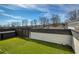 This rooftop deck features artificial grass and is surrounded by white walls and dark fences for added privacy at 4382 Benfield Se Way, Smyrna, GA 30080