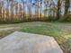 Spacious backyard with a patio and wooded backdrop at 890 Navajo Trl, Covington, GA 30016