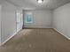 Bright and airy bedroom with neutral carpeting and a large window at 890 Navajo Trl, Covington, GA 30016