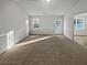 Bright living room with neutral carpeting and large windows at 890 Navajo Trl, Covington, GA 30016