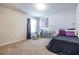 Well-lit bedroom with a black comforter and rocking chair at 145 Lost Cove Sw Dr, Atlanta, GA 30331