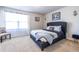 Bedroom with a dark gray upholstered bed and patterned throw blanket at 145 Lost Cove Sw Dr, Atlanta, GA 30331