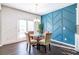 Bright dining area with glass table and four chairs, featuring a stylish blue accent wall at 145 Lost Cove Sw Dr, Atlanta, GA 30331