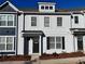 Modern two-story townhome with gray brick exterior and black shutters at 1822 Emory Ln # 89, Conyers, GA 30013