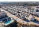 Aerial view of a large community with townhouses, pool, and open space at 4292 Foxtail Pine Aly, Doraville, GA 30360