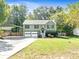Charming ranch home with carport, landscaped lawn, and two-car garage at 456 Pine Shadows Dr, Dallas, GA 30157