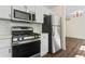 Modern kitchen featuring stainless steel appliances and white shaker cabinets at 456 Pine Shadows Dr, Dallas, GA 30157