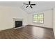 Living room featuring hardwood floors, a fireplace, and large window at 456 Pine Shadows Dr, Dallas, GA 30157