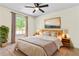 Main bedroom with king bed, wood accents, and large window at 456 Pine Shadows Dr, Dallas, GA 30157